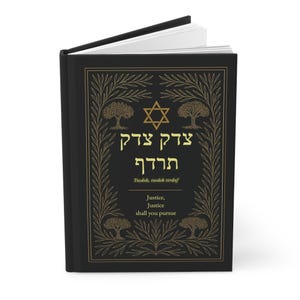 May include: A black journal with gold lettering and illustrations. The cover features Hebrew text, a Star of David, and the English text "Justice, Justice shall you pursue." The design includes tree and leaf motifs.