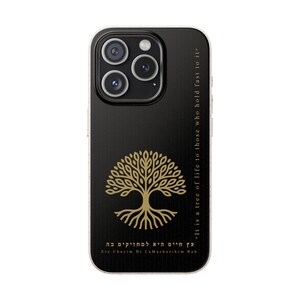 May include: Black phone case with a gold tree of life design. The case has the text "It is a tree of life to those who hold fast to it" and "Etz Chayim Hi La Machazikim Bah". The case is designed for a smartphone.