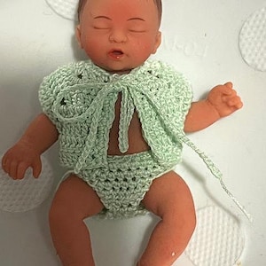 May include: A set of three ceramic mugs with a speckled, matte finish in cream, light grey, and dark grey. Each mug has a simple, minimalist design, suitable for coffee or tea.