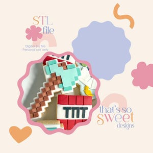 May include: Cookies decorated to resemble a pixelated axe and a TNT block. The axe has a light blue head and a brown handle. The TNT block is red with white accents and the letters "TNT". The image includes the text "STL file" and "that's so sweet designs".
