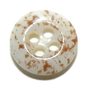May include: A round, off-white button with four holes and a speckled brown pattern. The button has a slightly raised rim and is made of a smooth, glossy material. Ideal for sewing projects.