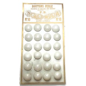 May include: Vintage card of pearl buttons, labeled "BOUTONS PERLE" with text "PATENTED IN ENGLAND AND AMERICA." The card features 24 round, off-white buttons arranged in rows. The card also has the text "DEPOT A PARIS" and the number "10."