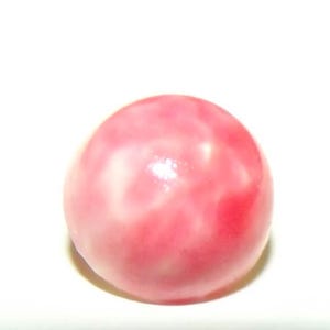 May include: A close-up of a pink, spherical object with a glossy finish. The object has a marbled appearance with lighter pink and white swirls throughout. The background is plain white.