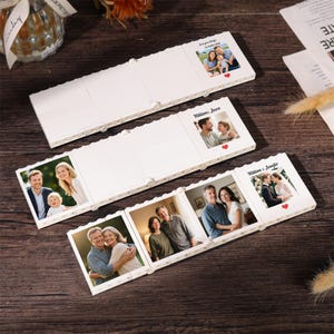 May include: Three white, interlocking, brick-style photo display frames. Each frame features a square photo insert, some with printed text like 'Love you always no matter what', 'William & Jason', or 'William & Jennifer' and small red heart icons.