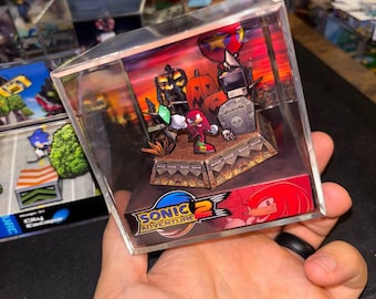 May include: A Sonic Adventure 2 diorama featuring Knuckles the Echidna in a Halloween-themed setting. The scene includes pumpkins, a tombstone, and a monitor. The diorama is encased in a clear acrylic box.