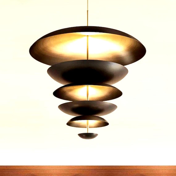 A handmade brass disk chandelier with Italian mid-century modern DNA — the kind of statement ceiling fixture that makes an entire room.