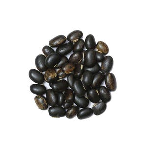 May include: A pile of black beans, oval-shaped with a smooth texture, against a white background. Some beans have a mottled, brown appearance. The beans are evenly distributed, filling the frame.