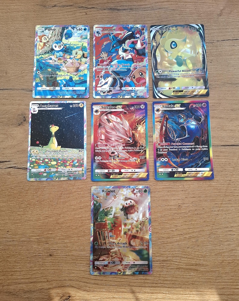 May include: A collection of seven rectangular trading cards featuring colorful illustrations of various creatures. The cards display names such as Piplup, Lucario, Celebi GX, Ampharos, Solgaleo GX, Lunala GX, and Rowlet, along with printed text and game statistics.