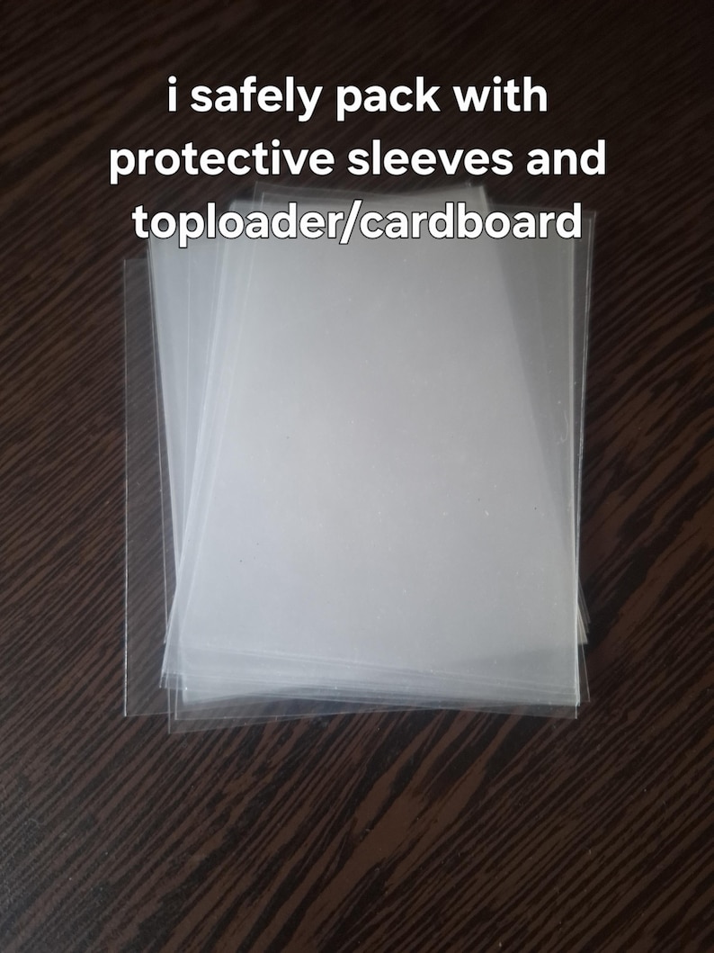 May include: A stack of clear, rectangular plastic protective sleeves for trading cards. The text "i safely pack with protective sleeves and toploader/cardboard" is overlaid on the image. These transparent sleeves are designed to hold and protect cards.