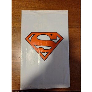 Death Of Superman Collectible in Unopened White Bag with Exclusive Trading Card, Removable Translucent Cover, and Exclusive 8 Extra Pages