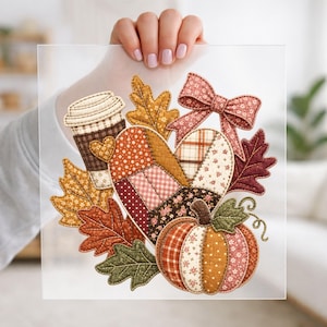May include: A square transparent sheet featuring a colorful patchwork-style illustration of a coffee cup, a heart, a bow, and a pumpkin, all surrounded by various autumn leaves in shades of orange, brown, red, and green with detailed stitching.