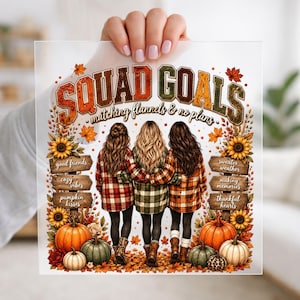 May include: A clear acrylic sign featuring the text SQUAD GOALS matching flannels & no plans. The design shows three people from behind wearing plaid shirts, surrounded by sunflowers, pumpkins, autumn leaves, and wooden signs with text.