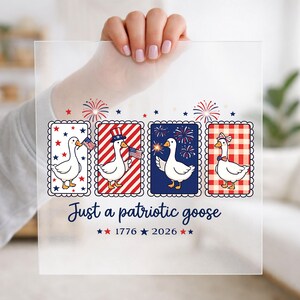 May include: A square acrylic sign featuring four rectangular panels with white geese. The geese are decorated with American flag motifs, fireworks, stars, and gingham patterns. The text reads Just a patriotic goose 1776 2026 with red and blue stars.