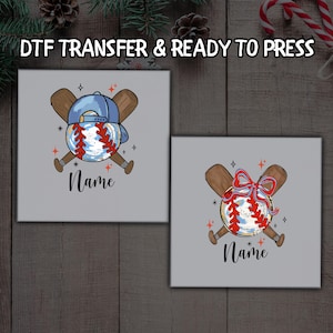 May include: Two square designs featuring baseball-themed graphics. One shows a baseball with a blue cap and crossed bats, the other a baseball with a red bow and crossed bats. Both include the word "Name" in script.