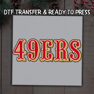 May include: A gray square canvas with the text "DTF TRANSFER & READY TO PRESS" at the top. The words "49ERS" are in large, red, gold, and white lettering, perfect for sports fans.