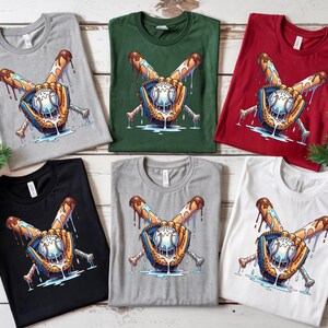 May include: A collection of t-shirts in various colors, including gray, green, red, black, and white. Each shirt features a baseball-themed graphic with a baseball, glove, and crossed bats with a dripping design.