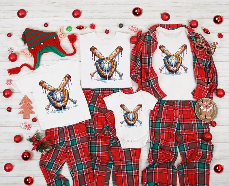 May include: A family set of matching Christmas pajamas. The set includes white t-shirts and a onesie, all featuring a baseball-themed graphic. The pajamas are paired with red and green plaid pants. Festive decorations surround the set.