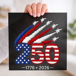 May include: Black square with embroidered design. Features the number "250" in red, white, and blue, with the "2" displaying white stars on a blue background. Above the number are red, white, and blue streaks with white airplane designs. The text "-1776 * 2026-" is at the bottom.
