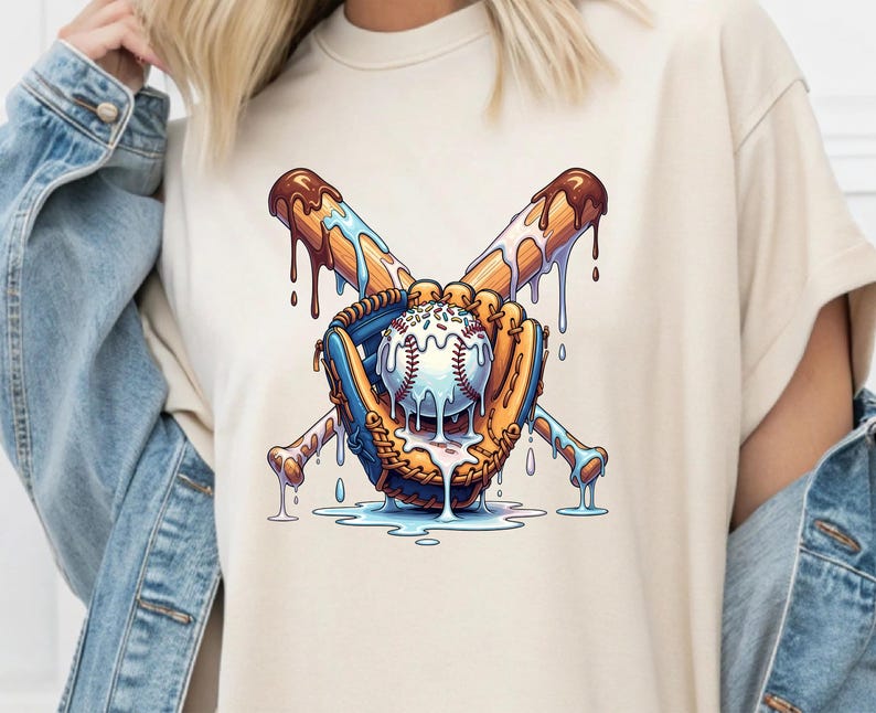 May include: Cream-colored t-shirt featuring a baseball-themed graphic. The design includes a baseball, a glove, and crossed bats, all with a melting ice cream effect. The baseball is white with red stitching, and the bats are brown with dripping chocolate.