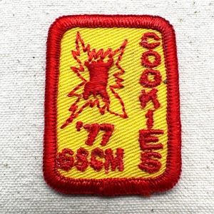 May include: A white ceramic mug with a black handle and the text "But First, Coffee" in a black, bold font. The mug is on a white surface. The mug is likely for hot beverages.