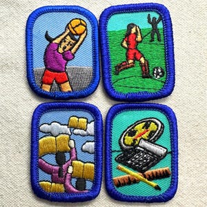 May include: Four rectangular embroidered patches with blue borders. The top left shows a figure holding a yellow ball. The top right depicts a soccer player on a green field. The bottom left shows figures with yellow books. The bottom right features a compass, calculator, and ruler.