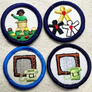 May include: Four circular embroidered patches with dark blue borders. The top left shows a figure at a podium. The top right features three stylized figures in yellow, black, and white with red hearts. The bottom two show a brown computer monitor.