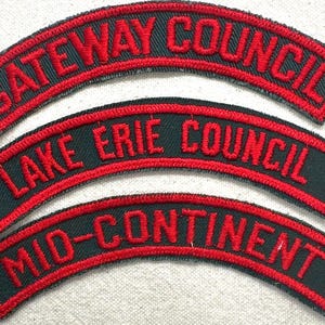 May include: Three embroidered patches with arched text. The top patch reads "GATEWAY COUNCIL" in red thread on a dark green background. The middle patch says "LAKE ERIE COUNCIL", and the bottom patch says "MID-CONTINENT".