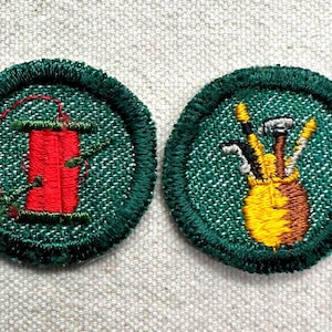 May include: Two round green embroidered patches. One features a red spool of thread with green vines. The other shows a yellow and brown golf bag with golf clubs. Both have a green border.