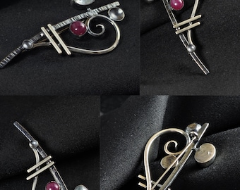 May include: Four silver-toned hair clips with a unique design. Each clip features a combination of straight bars, curved lines, and small, round gemstones in clear and red hues. The text "No: 1" is in the top left corner.