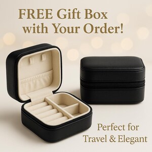 May include: Black travel jewelry case, one open and one closed, with a beige interior. The open case displays ring slots and compartments. Text reads "FREE Gift Box with Your Order!"