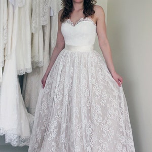 Lace wedding skirt in A-line silhouette made in delicate Chantilly lace over tulle and satin under layers.