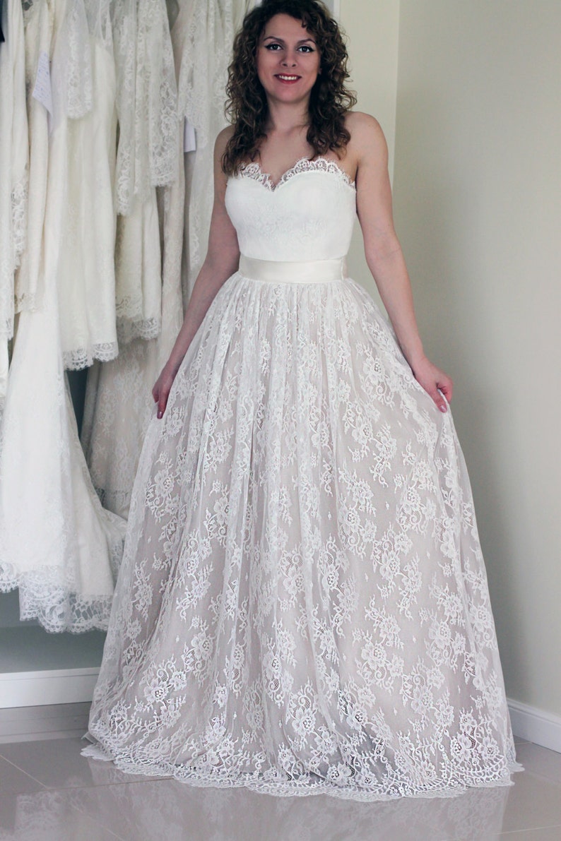 Lace wedding skirt in A-line silhouette made in delicate Chantilly lace over tulle and satin under layers.