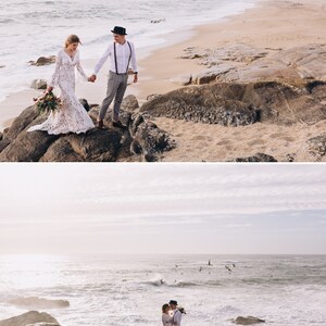 May include: A couple standing on coastal rocks by the ocean. One individual wears a long-sleeved white lace gown and holds a floral bouquet. The other wears a white button-down shirt, grey trousers, brown suspenders, and a dark fedora hat.