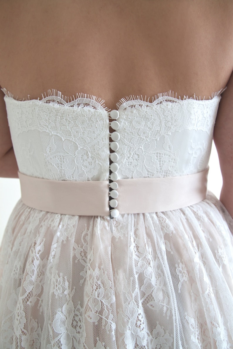 Lace wedding dress in A-line silhouette made in delicate Chantilly lace over tulle and satin under layers.