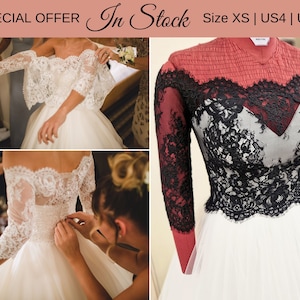 May include: A white wedding dress with an off-the-shoulder lace bodice and long sleeves. The dress features intricate lace detailing and a full skirt. The image also shows a red and black lace top with a white skirt. Text on the image says "SPECIAL OFFER" and "In Stock".