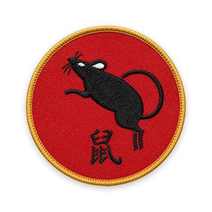 May include: A circular embroidered patch featuring a red background with a gold border. The design includes a black rat silhouette with white ear detail and the black Chinese character for rat positioned below the animal on the red fabric surface.