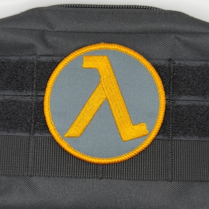 Lambda-patch: opnaaien, opstrijken of klittenband