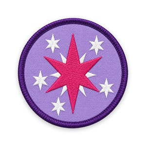 May include: A circular embroidered patch featuring a lavender background with a dark purple stitched border. The design displays a large, vibrant pink six-pointed star layered over smaller white stars, creating a celestial pattern.