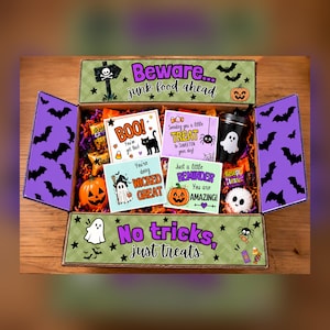 May include: A Halloween-themed gift box filled with candy, a small pumpkin, a ghost-printed cup, and four cards with text including "BOO! You're got this!", "Sending you a little TREAT", "You're doing WICKED GREAT", and "Just a little REMINDER".
