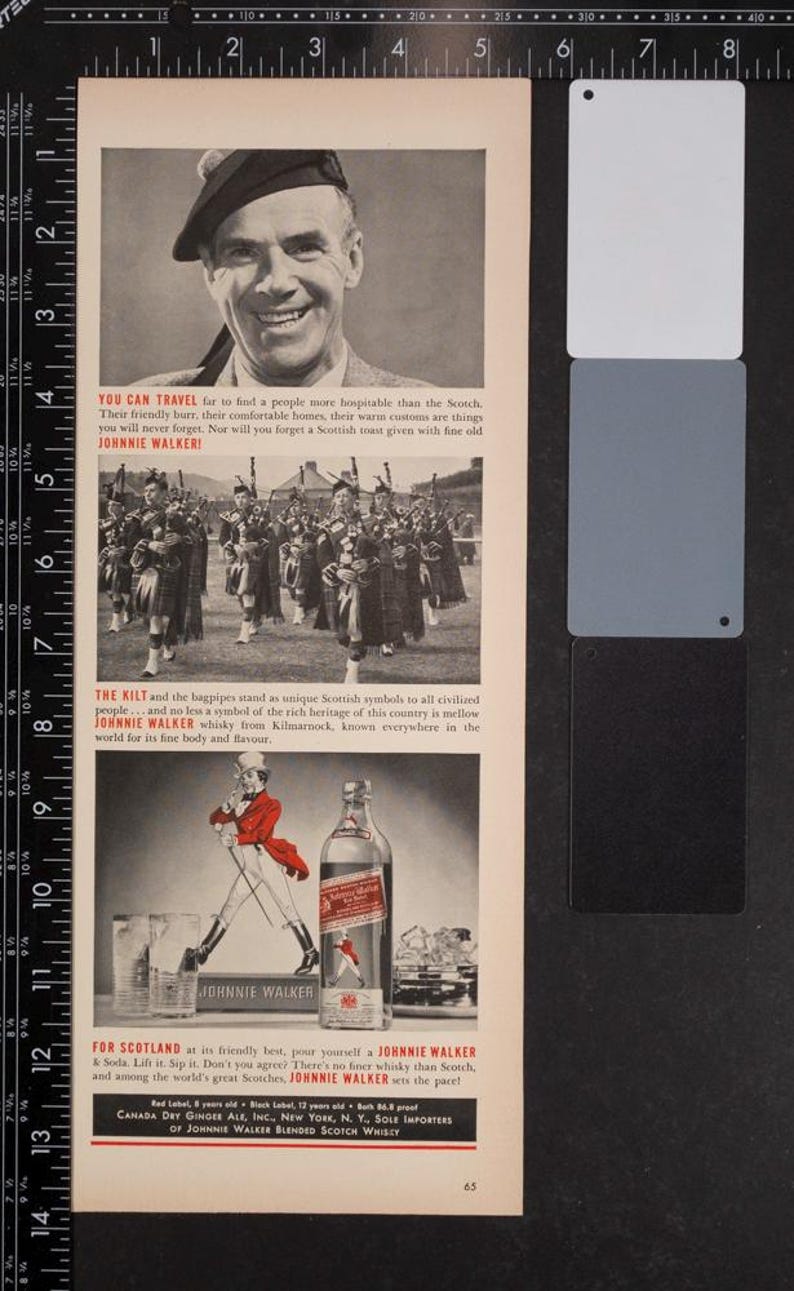 May include: An old advertisement for Johnnie Walker whisky. The image shows a smiling man, a bagpipe band, and a man in a red coat. The text includes "Johnnie Walker" and references Scotland and its heritage.