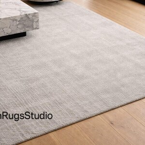 Transform your living space with the timeless elegance and unmatched comfort of our Hand Tufted New Zealand Wool Rug, thoughtfully designed to bring luxury, warmth, and modern sophistication into your home. This premium wool rug is a perfect blend of minimalist design, natural materials, and artisan craftsmanship, making it an ideal choice for modern, contemporary, and luxury interiors
