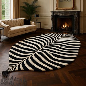 May include: A striking leaf-shaped rug featuring black and cream stripes. The rug is positioned on a dark wood floor, creating a focal point in a living room. The design mimics a giant leaf.