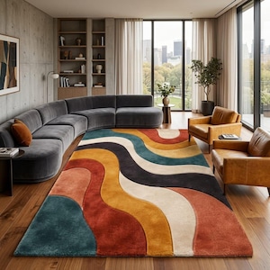 May include: A rectangular area rug featuring a wavy, multi-colored pattern of teal, burnt orange, mustard yellow, cream, and dark charcoal. The rug has a thick, plush texture and covers a large portion of the wooden floor in a living room.