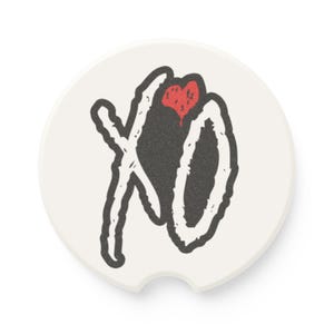 May include: A white car coaster with a black and red XO graphic. The design features the letters "XO" in a stylized font, with a red heart shape in the center. The coaster has a small notch for easy removal from a car cup holder.