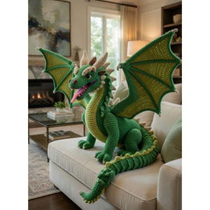 May include: A large, handmade crochet dragon in shades of green and yellow. The dragon has large wings, a long tail, and a pink tongue. It is sitting on a cream-coloured sofa, with a detailed design.