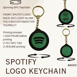 May include: A green and black Spotify logo keychain with a gold-coloured ring and chain. The front displays the Spotify logo, and the back has an NFC logo. The image includes the text "Spinning NFC Keychain" and "Spotify Logo Keychain."