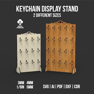 Pode incluir: Dois expositores de madeira para chaveiros. Um é bege claro, o outro é marrom. Cada um tem vários ganchos para exibir chaveiros. O texto na imagem diz "KEYCHAIN DISPLAY STAND" e "2 DIFFERENT SIZES". A imagem também inclui informações sobre o tipo de arquivo.