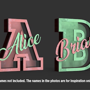 May include: Two 3D wooden letters, A and B, in a dark setting. The letter A is a reddish-pink with the name "Alice" in a light green script. The letter B is a light green with the name "Brian" in a reddish-pink script. The names are for inspiration only.