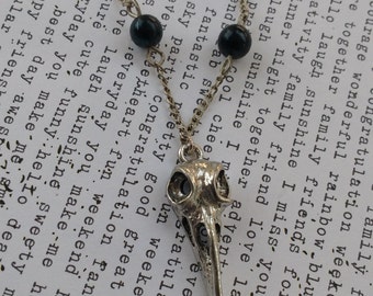 Bird skull hummingbird skull necklace in a silver tone