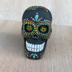 Hand painted sugar skull figurine dot art in green, yellow and orange